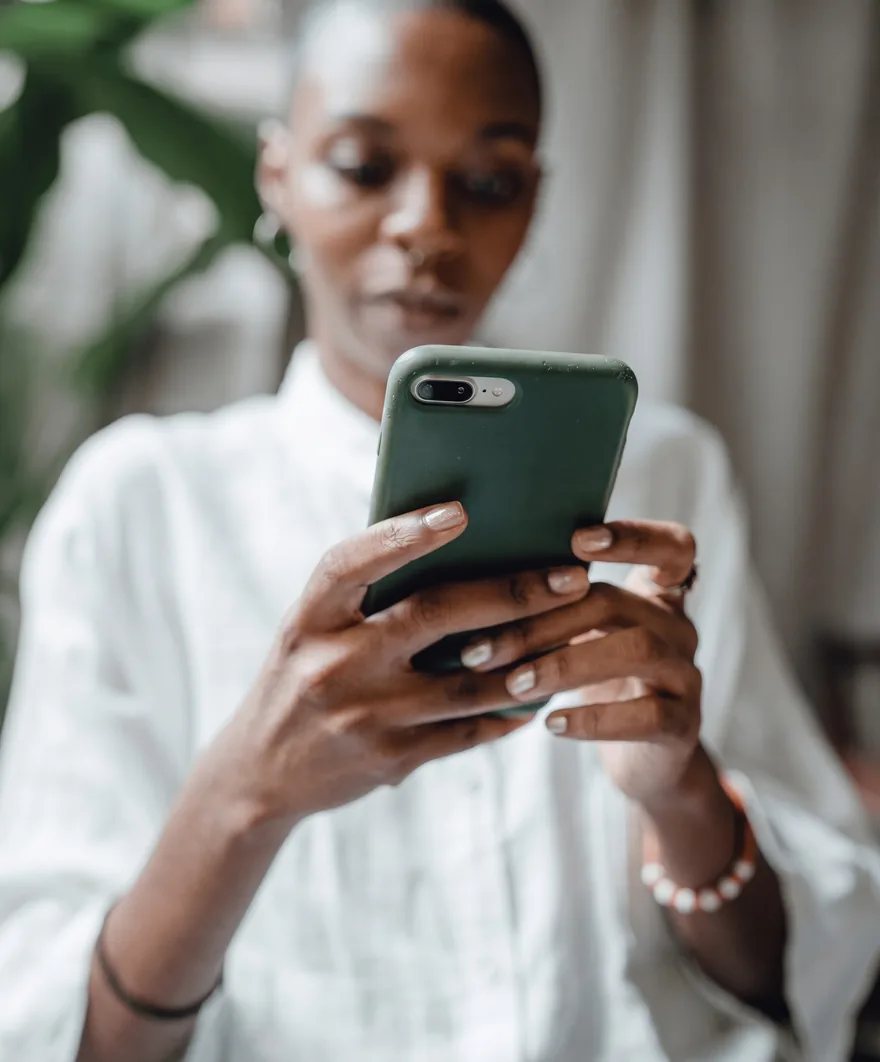 Someone booking something on a phone held in both hands